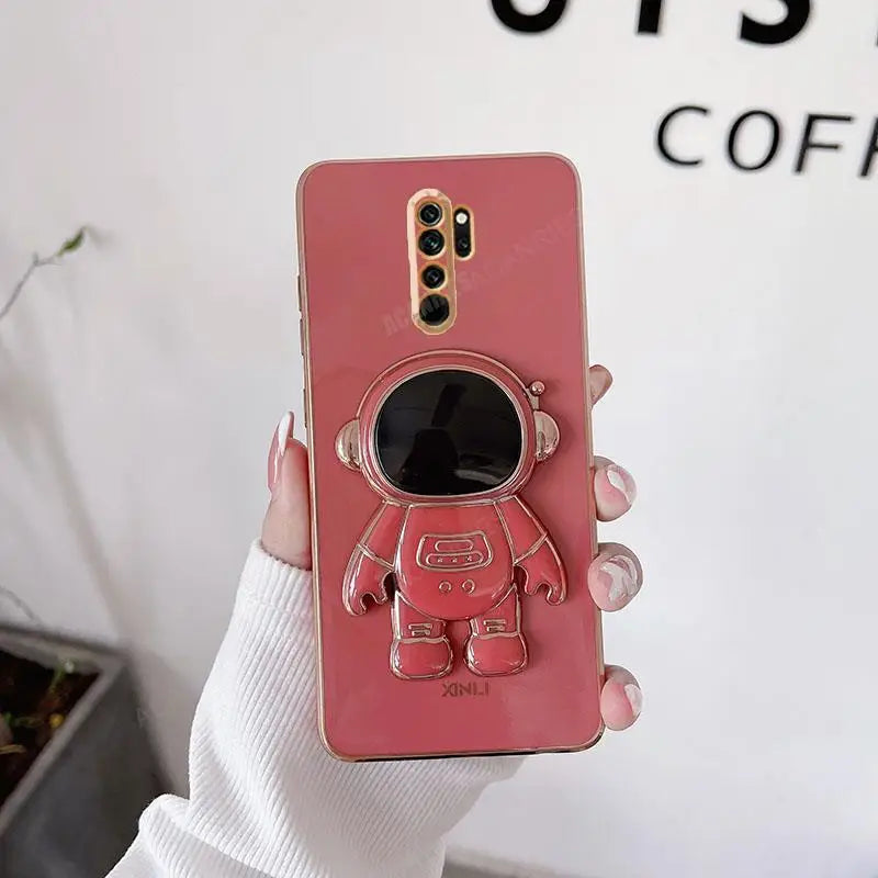 a woman holding a pink phone case with a camera