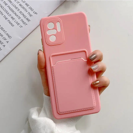 a woman holding a pink phone case