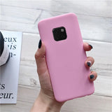 a woman holding a pink phone case