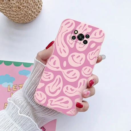 a woman holding a pink phone case