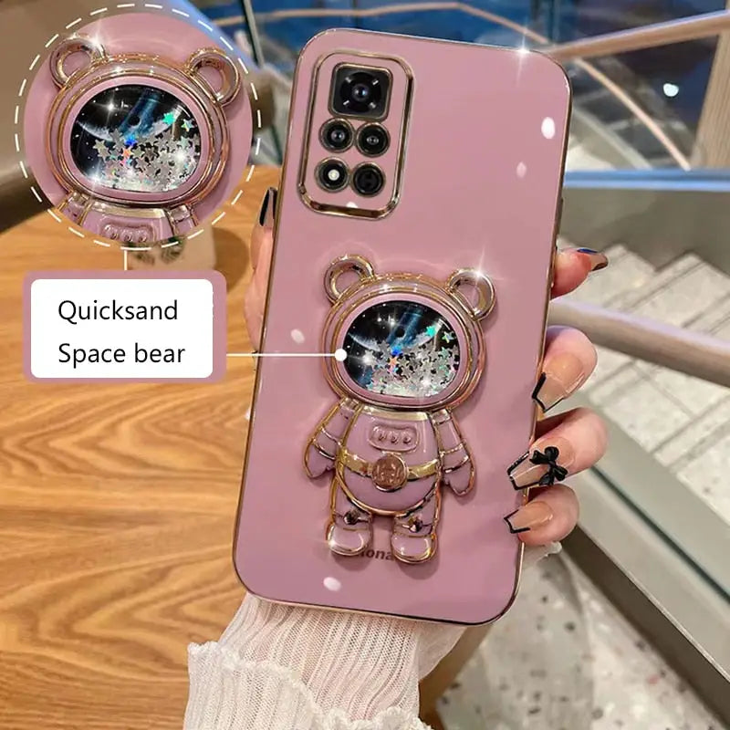 a pink phone case with a cute cat on it