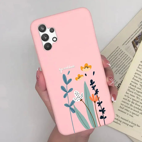 a woman holding a pink phone case with flowers on it