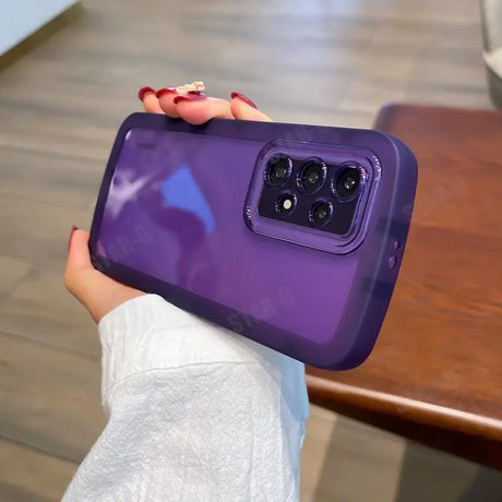 a woman holding a purple phone case