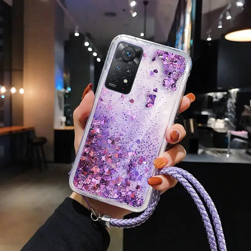 a woman holding a purple glitter phone case