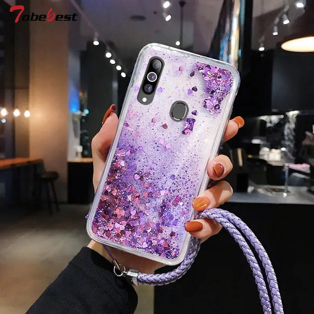 a woman holding a phone case with purple glitter