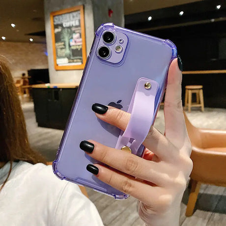 a woman holding up a purple phone case