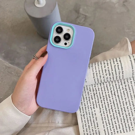 a woman holding a purple iphone case