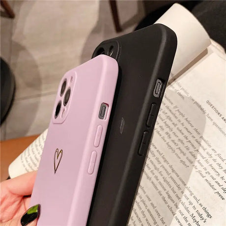 a woman holding a purple phone case