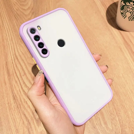 a woman holding a purple phone case