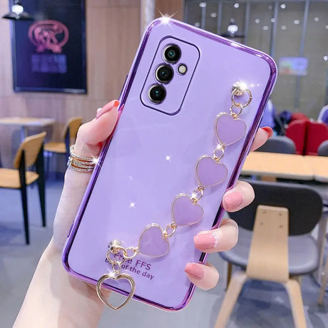 a woman holding a purple phone case with a heart ring