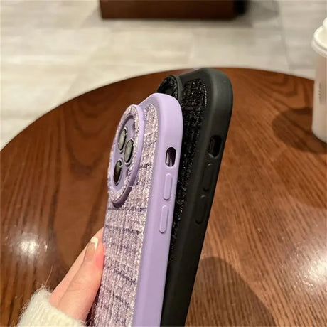 a woman holding a purple phone case