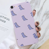 a woman holding a purple phone case with a pattern of blue and white cats on it
