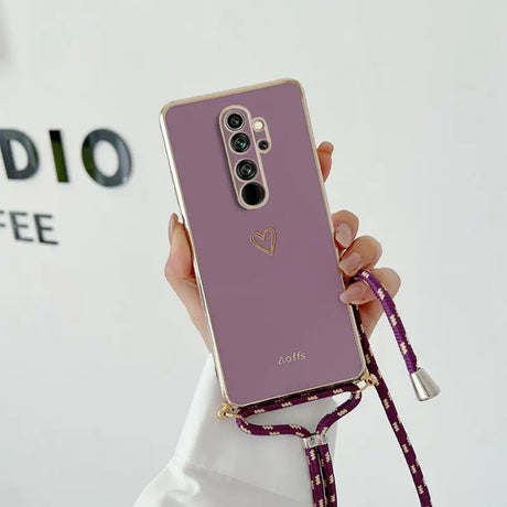 a woman holding a purple phone case