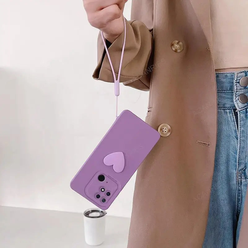 a woman holding a purple phone case