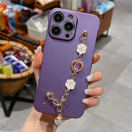 a woman holding a purple phone case with a chain attached to it