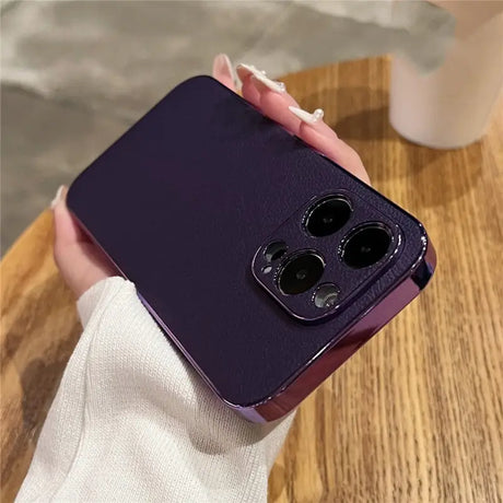 a woman holding a purple phone case