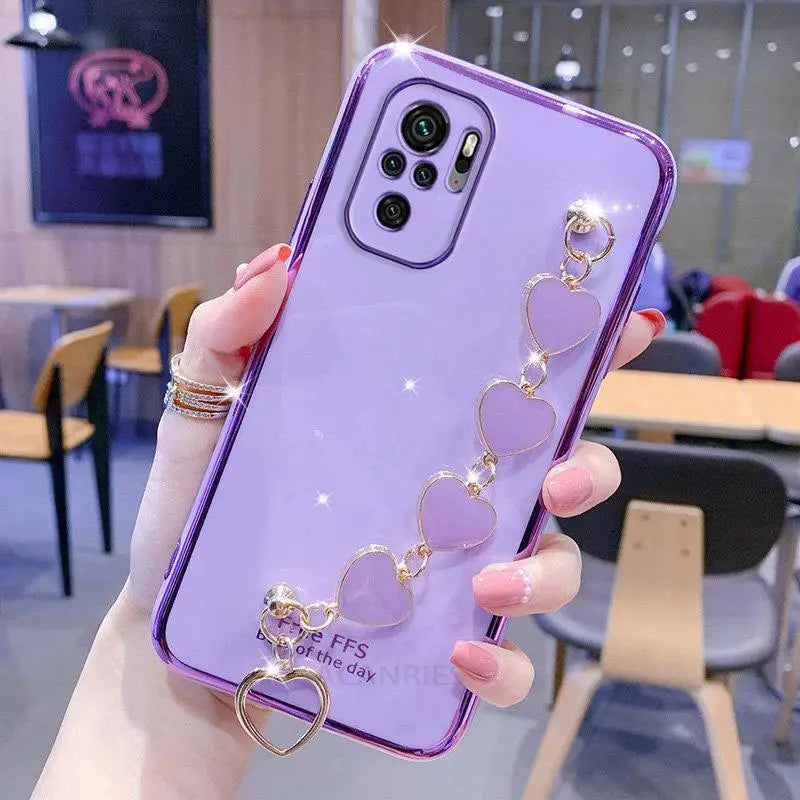 a woman holding a purple phone case with a heart ring