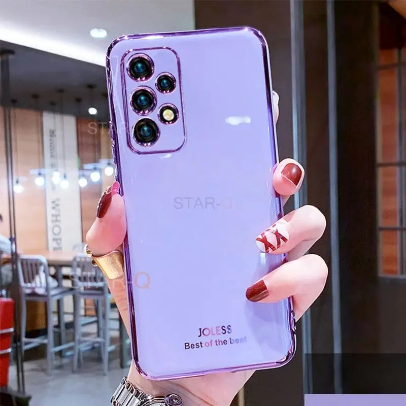 a woman holding up a purple phone case