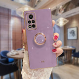 a woman holding a purple phone case with a ring on it