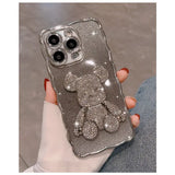 a woman holding a silver glitter iphone case