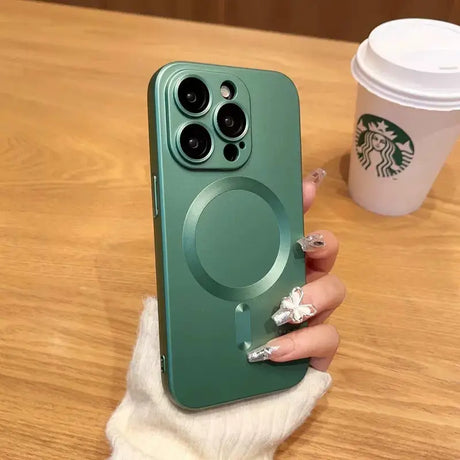 a woman holding a green phone case with a starbucks cup in the background