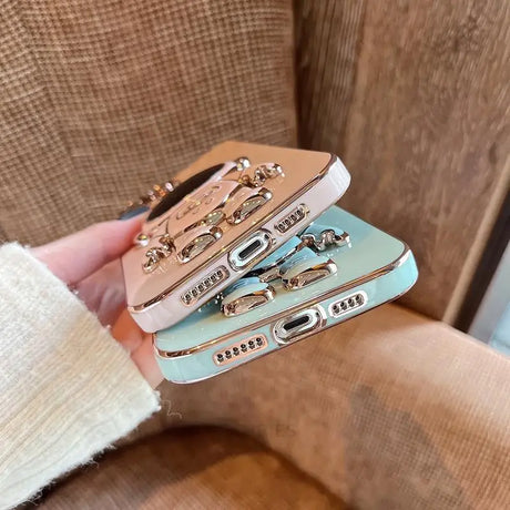 a woman holding three different colored leather wallets