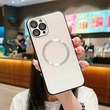 a woman holding up a white iphone case