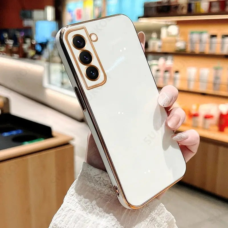 a woman holding a white iphone case