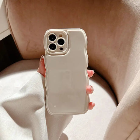 a woman holding a white phone case