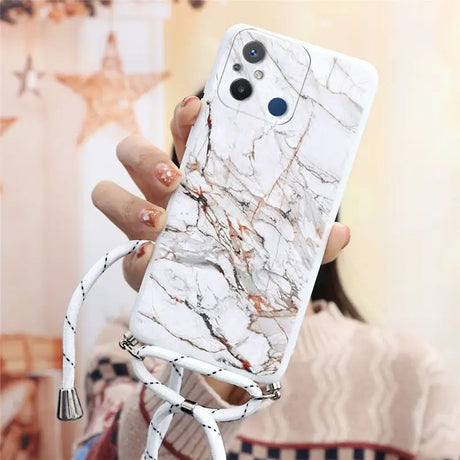 a woman holding a white phone case with marble pattern