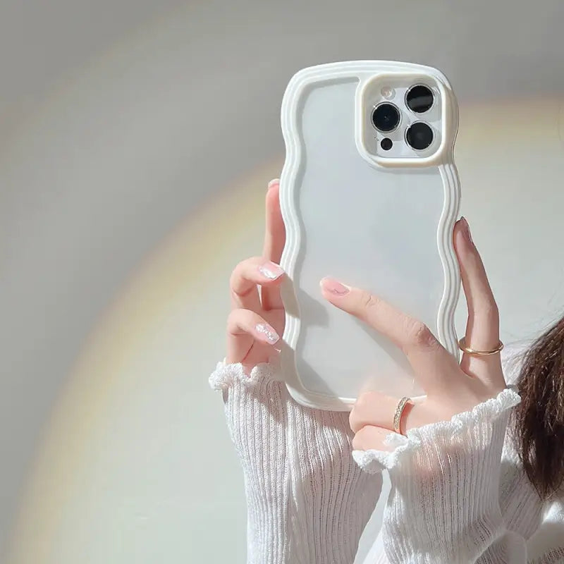 a woman holding a white phone case