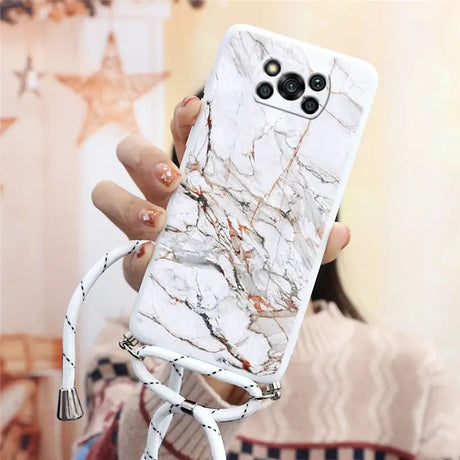 a woman holding a white phone case with marble pattern