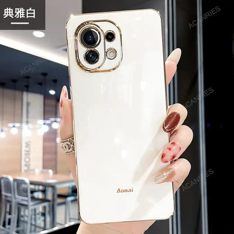 a woman holding a white phone case