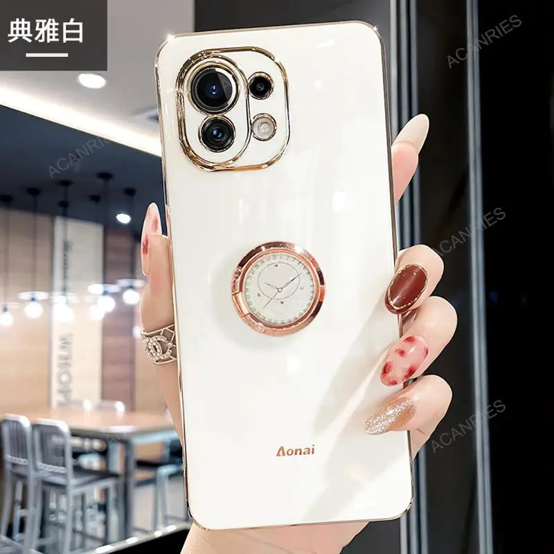 a woman holding a white phone case with a watch on it