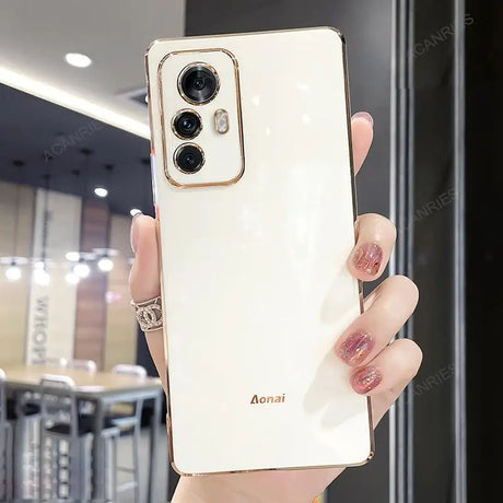 a woman holding a white phone case