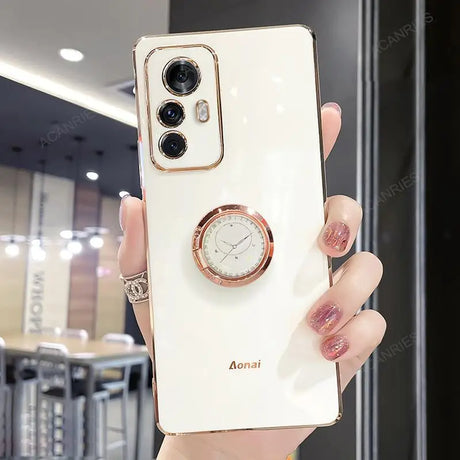 a woman holding a white phone with a watch on it