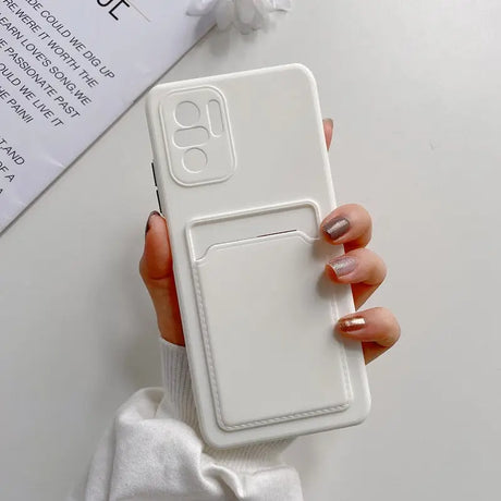 a woman holding a white phone case