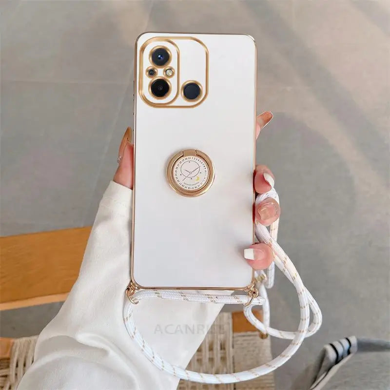 a woman holding a white phone case with a gold ring