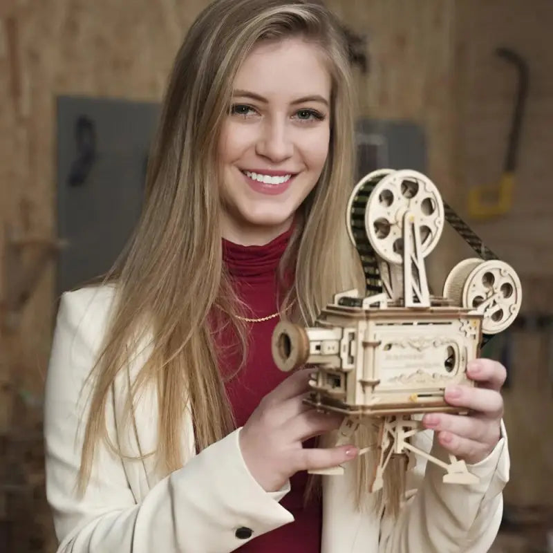 a woman holding a wooden camera