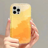 a woman holding a yellow iphone case
