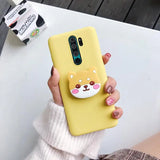 a woman holding a yellow phone case with a cat face