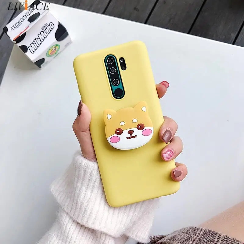 a woman holding a yellow phone case with a cat on it