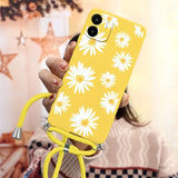 a woman holding a yellow phone case with white flowers on it