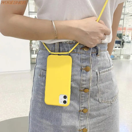 a woman holding a yellow phone case