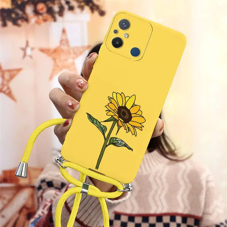 a woman holding a yellow phone case with a flower