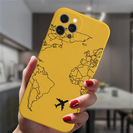 a woman holding a yellow phone case with a world map on it