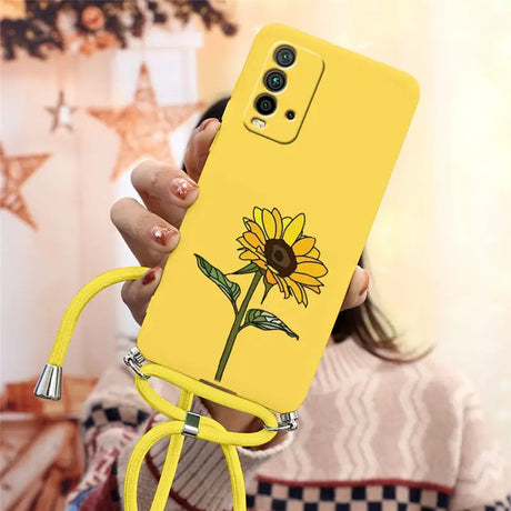 a woman holding a yellow phone case with a flower