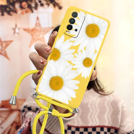 a woman holding a yellow phone case with white flowers on it