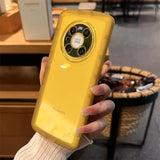 a woman holding a yellow phone case