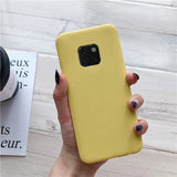 a woman holding a yellow phone case